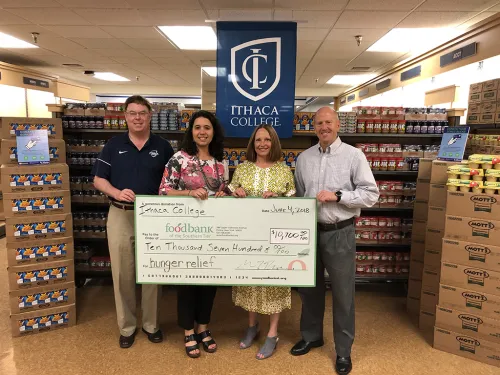 David Prunty, Natasha Thompson, Rebecca Sexton, and Jeffrey Scott with a check for $10,700