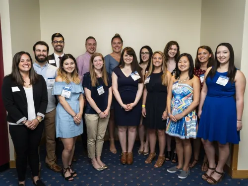 A group of men and women posing for a photo.