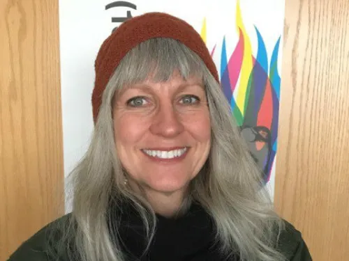 A woman poses with a smile. 