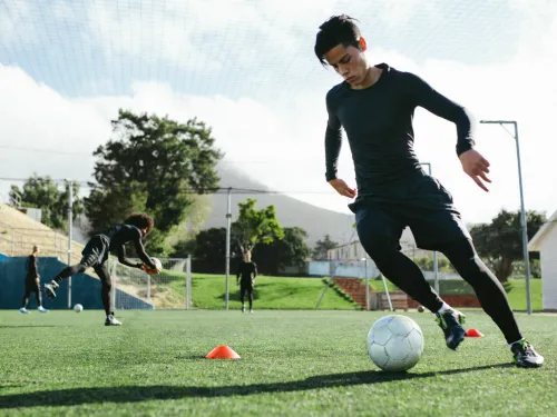 A man dribbles a soccer ball