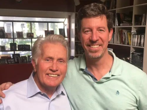 Two men standing arm in arm