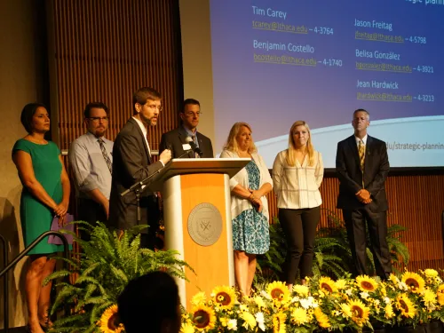 People standing behind a podium on stage