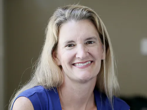 A blonde-haired woman smiling