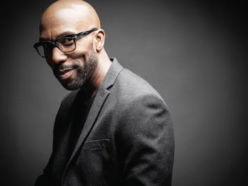 A man wearing glasses and a suit