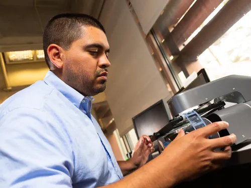 Gustavo Licón using a microfilm reader