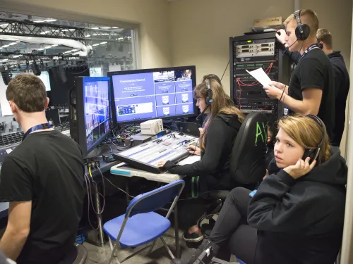 Students work behind the scenes at a symposium at Ithaca College