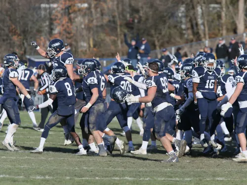 Ithaca players celebrate during the 2017 Cortaca Jug