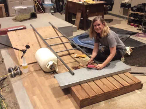 An alumna makes sound effects using a pine cone.