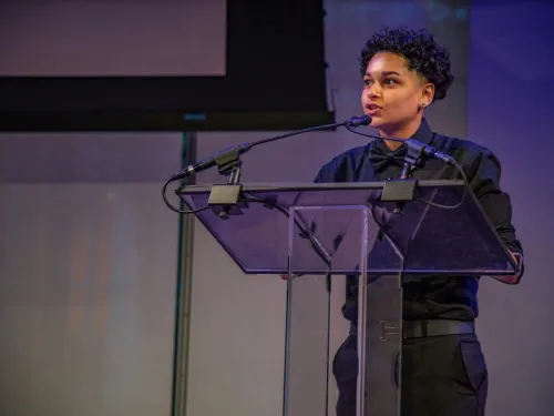 A young man speaking at a lecturn