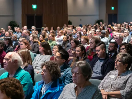 A full room of people sitting