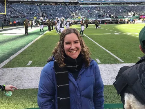 A young woman standing on a football field