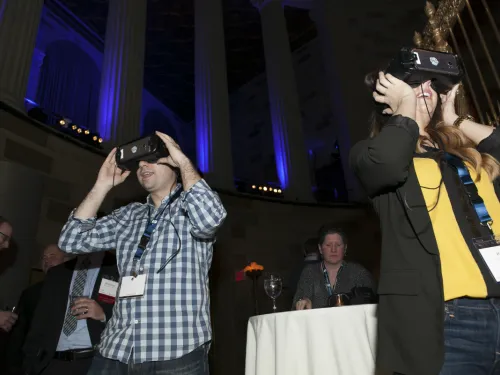 Two people wearing virtual reality goggles