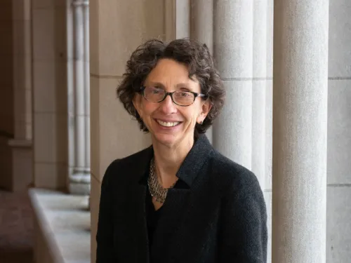 A woman in front of columns