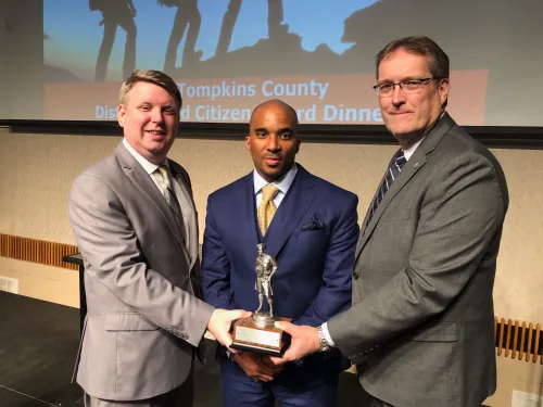 Three men with a trophy