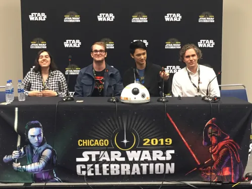 Three men and one woman sitting at a table