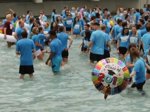 people in the fountains and a balloon that says Class of 2019