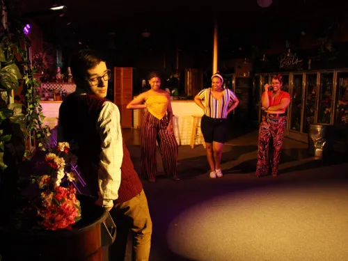 Four performers in a flower shop