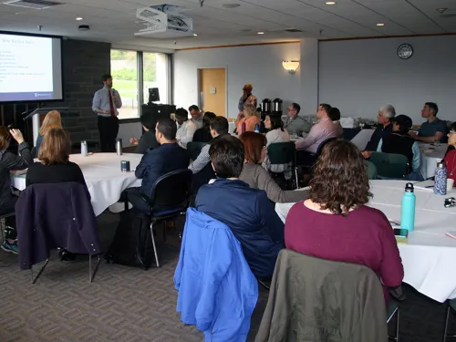 People sitting listening to a speaker