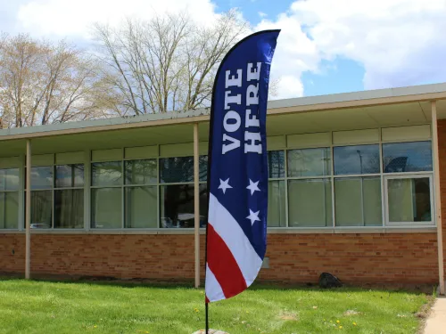 vote here flag in front of a school