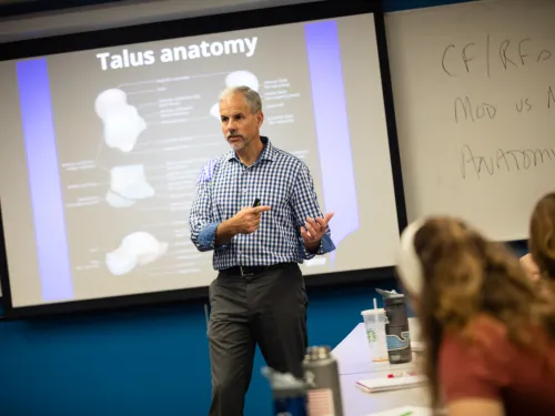 A man lecturing in a classroom