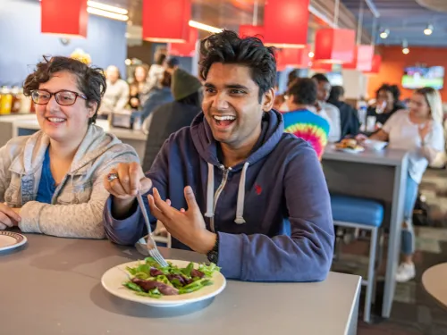 Two young people sitting at a restaurant table