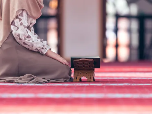 A young woman kneeling in a mosque