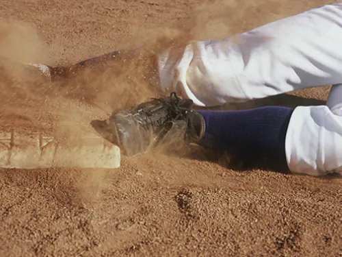 baseball player sliding into base