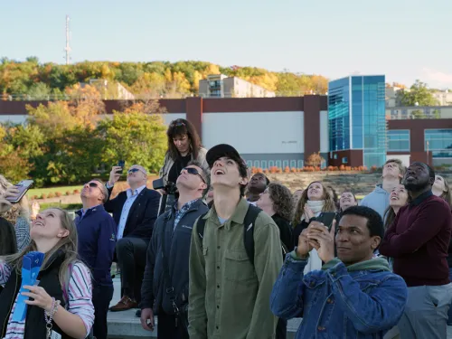 people watching a rocket in the sky