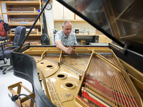 man tuning a piano