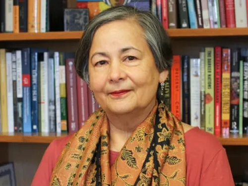 woman in front of bookshelf