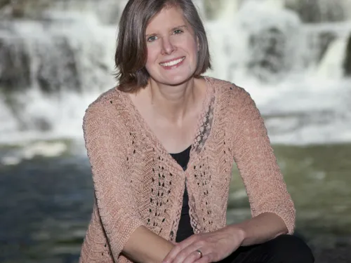 woman in front of waterfall