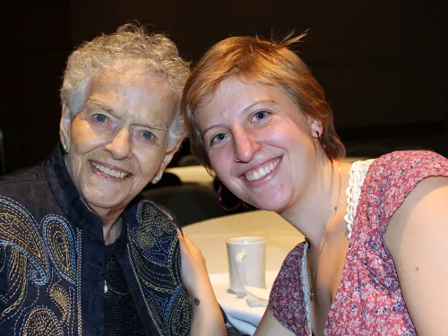 two women smile at the camera