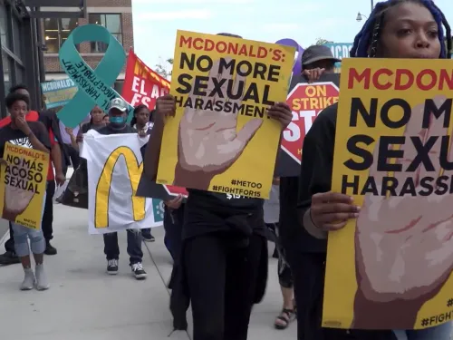 women holding signs that read "No more sexual harassment"