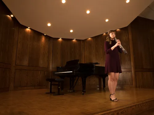 Student playing oboe on stage