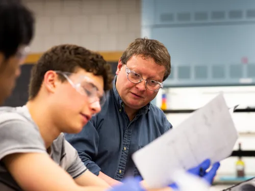 male professor working with a male student