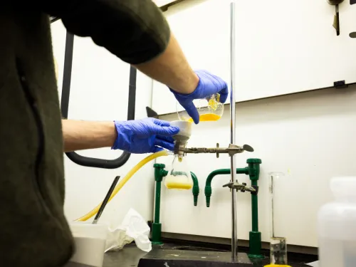Student conducting research during a chemistry lab.
