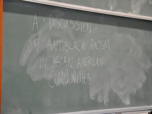 Text on a black board reading "A discussion on anti-black racism in asian american communities"