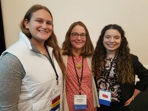 three women at a conference