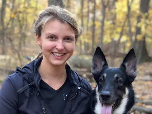 young woman with dog in the woods