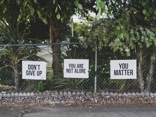 don't give up. You are not alone, you matter signage on metal fence. Photo by Dan Meyers on Unsplash