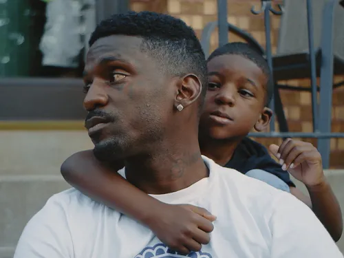 man and his son sitting on steps