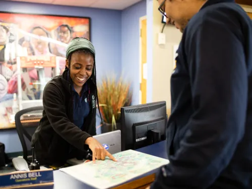 A student working at the Campus Center Information Desk.