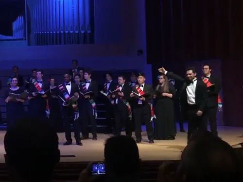 Performers stand on stage