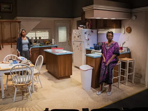 two women in a kitchen in a play