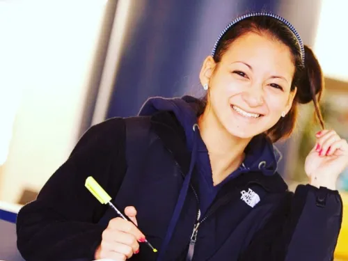 woman working on a stack of papers