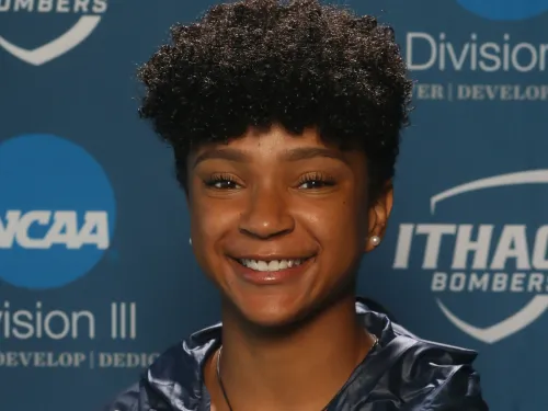 a young IC athlete with an IC zip up smiles for the camera