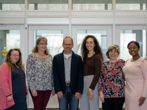 a group of faculty and students standing side by side.