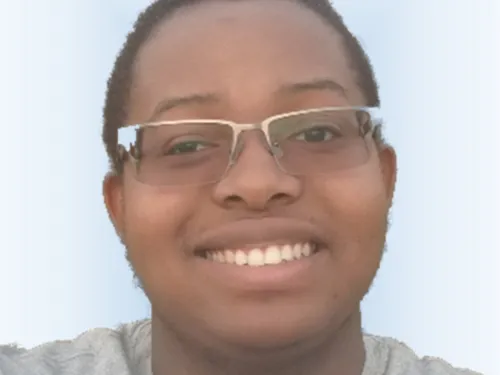 A photo of a young man, Jediah, with glasses in the center of the frame.