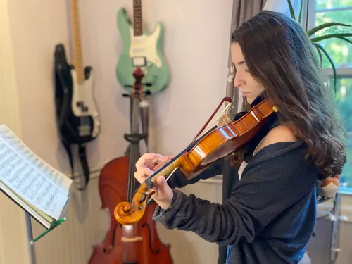 student playing a violin