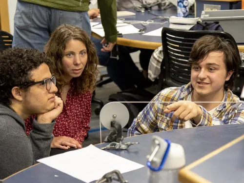 Students working with a pendulum lab in intermediate level physics classes.